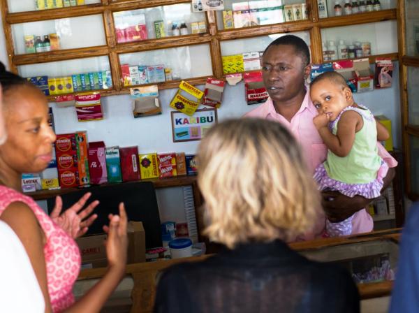 IntraHealth staff speaking with pharmacist in Tanzania