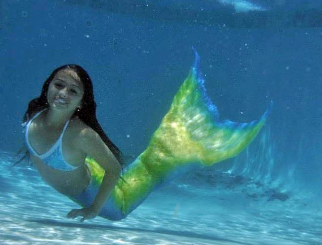 Jazz Jennings, a trans teen author, swimming underwater in her mermaid tail.